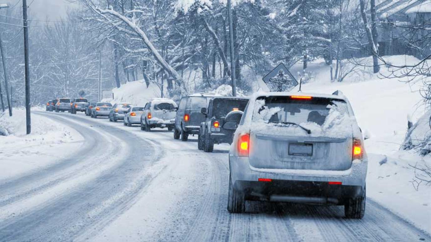 Traffic jam of cars on a snowy road