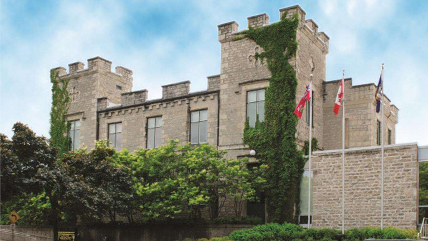 County of Wellington Administration Building with green vines climbing the stone.