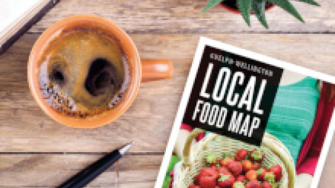 Local Food Map sitting on a table next to a cup of espresso and pen