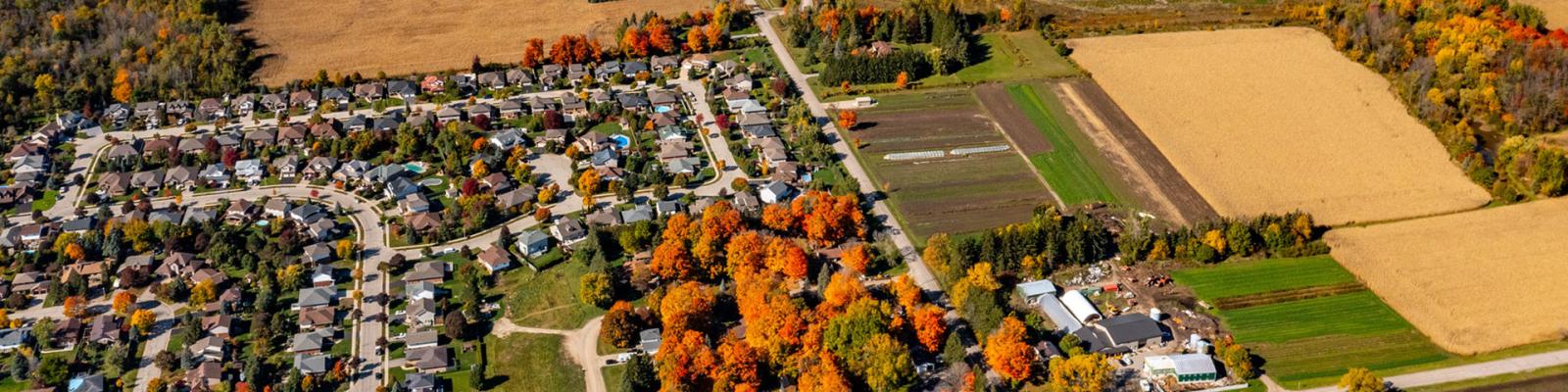Aerial view of rural neighbourhood bordering farmers fields
