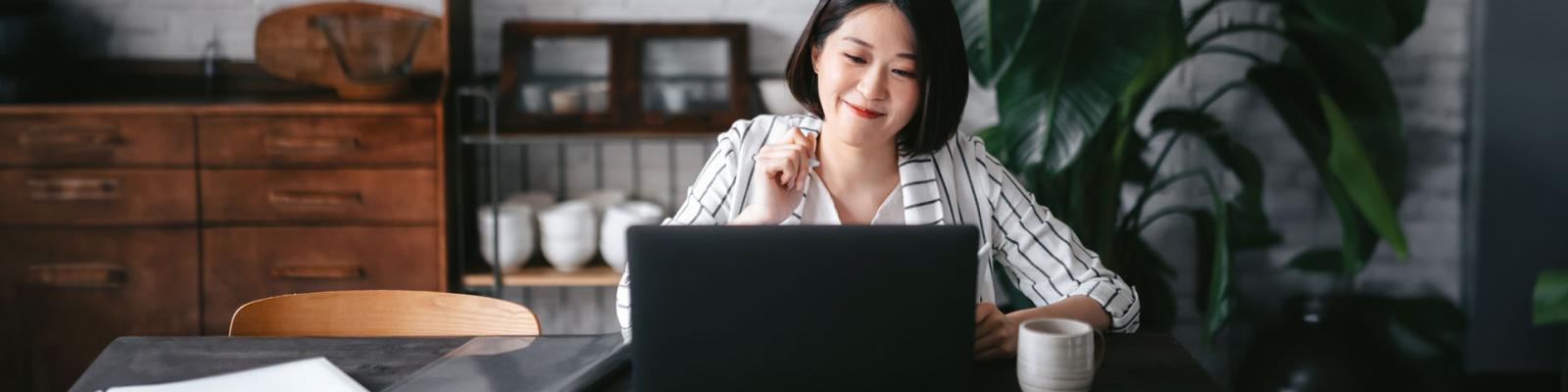 Young woman having online business meeting to review business financing