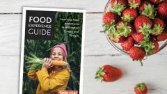 Food Experience Guide next to a bowl of strawberries