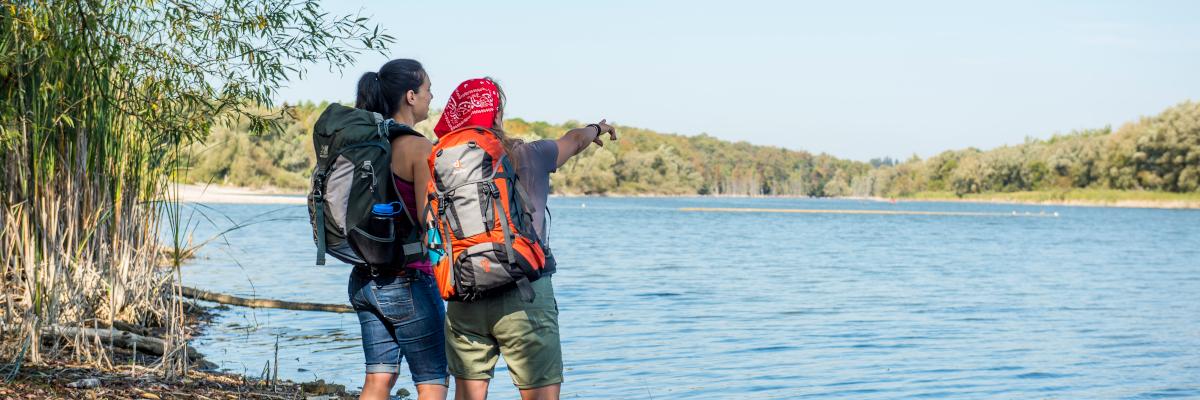 two hikers along waterfront