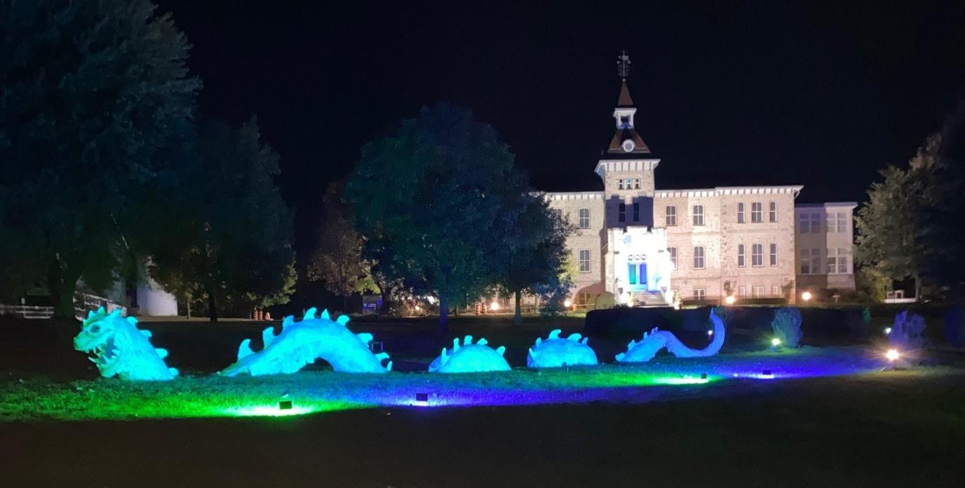 Front View of Wellington County Museum showcasing blue and green lights.