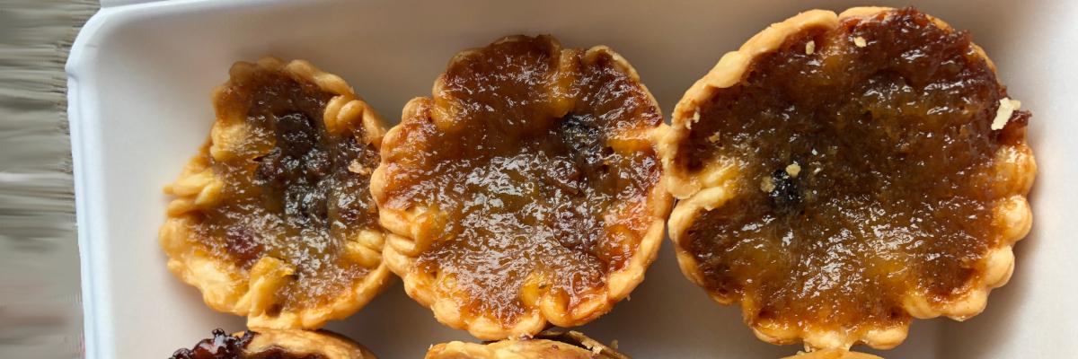 three butter tarts in a container
