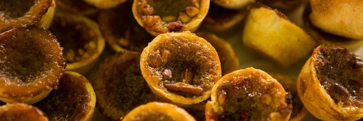 Close-up of baked tart shells filled with a golden filling